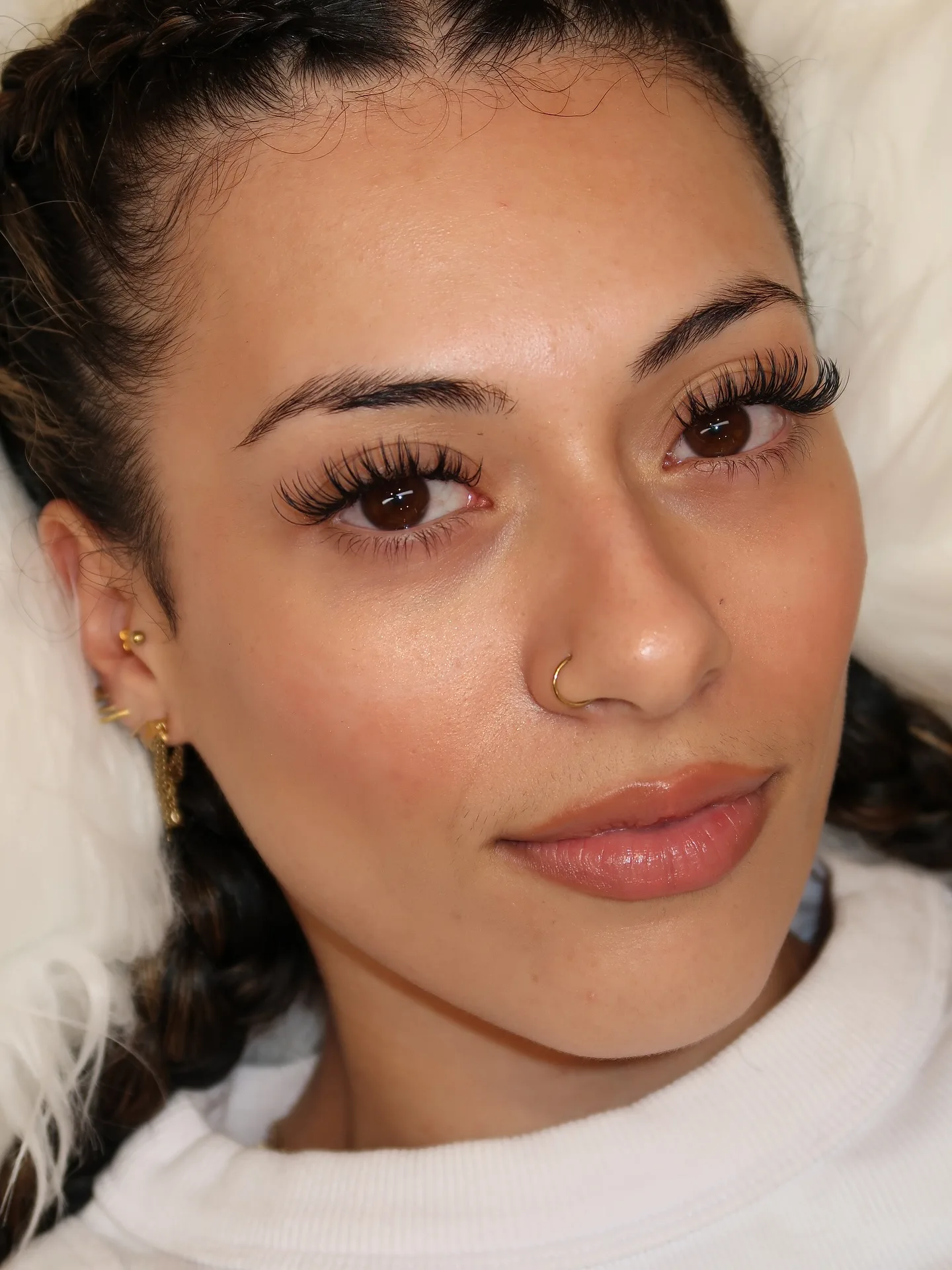 Full face, braided dark hair, both eyes with volume lashes, gold nose ring