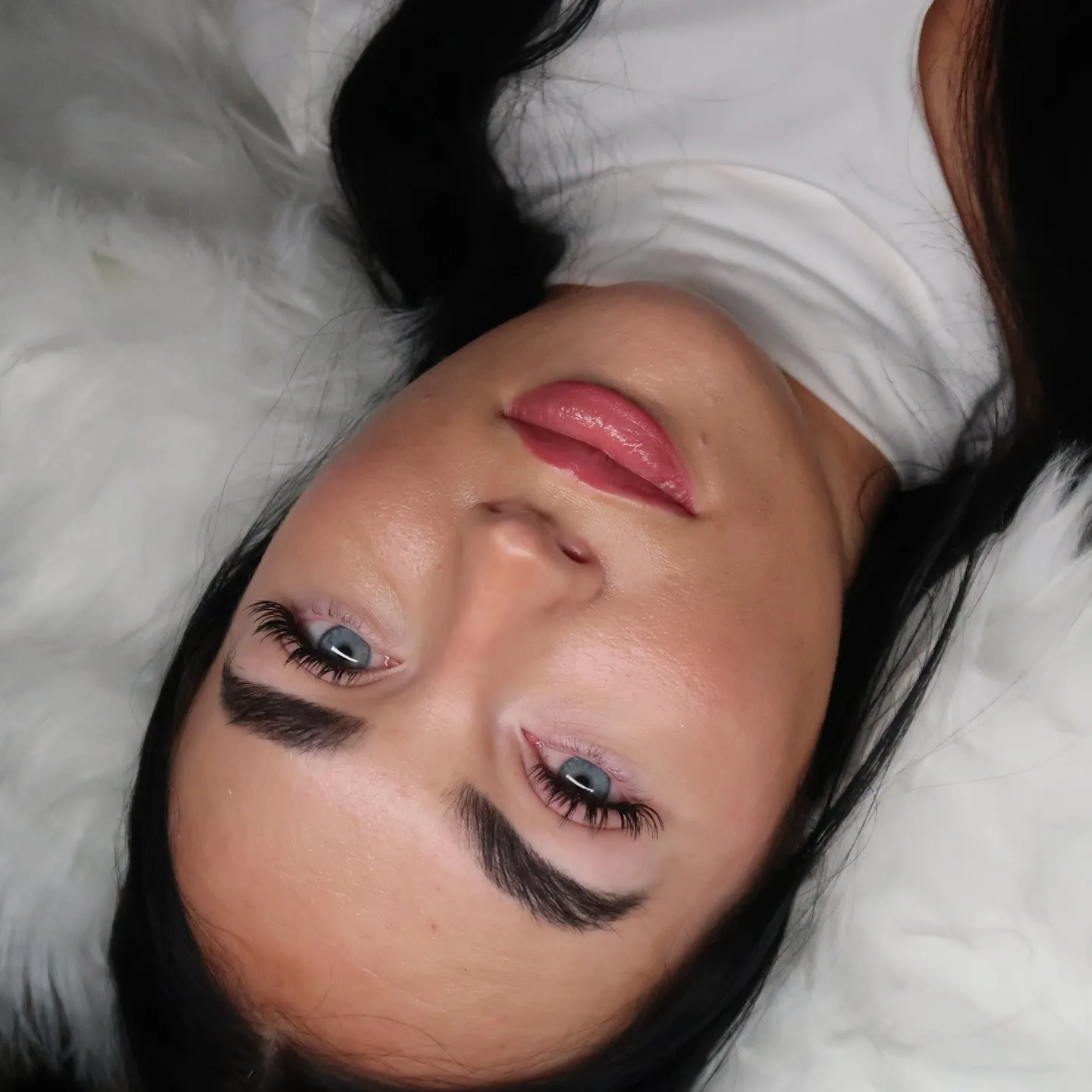 Both eyes with lash extensions, dark hair, bold dark brows